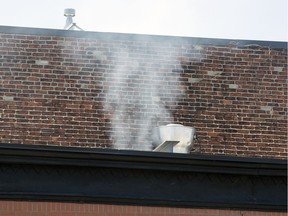 Smoke is exhausted from a restaurant in the Plateau Mont-Royal borough of Montreal Monday July 8, 2019. Montreal's public health department has released a study on the level of smoke in the vicinity of businesses that burn wood.