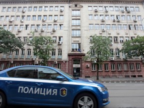 A police car passes past Bulgaria's National Revenue Agency building in Sofia, Bulgaria, July 16, 2019.