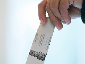 A woman casts her ballot in the riding of Vaudreuil-Soulanges, west of Montreal, on election day, Monday, Oct. 19, 2015.