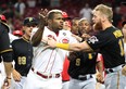 Yasiel Puig #66 of the Cincinnati Reds is restrained during a bench clearing altercation in the 9th inning of the game against the Pittsburgh Pirates at Great American Ball Park on July 30, 2019 in Cincinnati, Ohio.