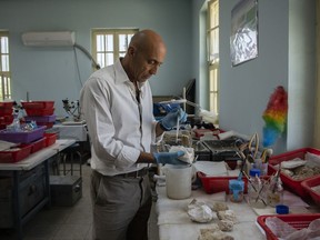 Fabio Colombo, senior conservator and the head of a restoration project at the National Museum of Afghanistan in Kabul, Afghanistan, sifts through remnants of Buddha figurines in June, 2019.