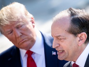 US President Donald Trump (L) listens to US Labor Secretary Alexander Acosta during a media address early July 12, 2019 at the White House in Washington, DC.