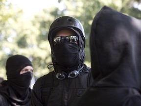 Antifa demonstrators wear bandanas over their faces during a protest to oppose the right-wing group "The Patriot Prayer Movement," which was having a rally in downtown Portland, Ore., on Sept. 10, 2017.
