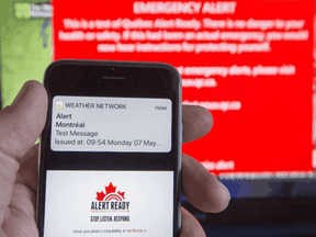 A smartphone and a television receive alerts to test Alert Ready, a national public alert system in Montreal. The system is not limited to Amber Alerts, but is capable of communicating any kind of warning to the public.