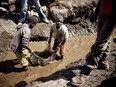 Children wash copper at an open-air mine in the mining province of Katanga, DRC. Children often drop out of school in order to earn some money from the mines.