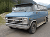 The blue 1986 Chevrolet van being driven by Lucas Fowler and Chynna Deese.