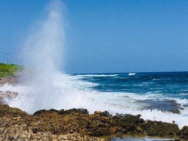 Blowholes shoot water up on Grand Cayman's south shore.