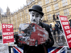 An anti-Brexit protester demonstrates outside the Houses of Parliament in London on March 12, 2019.
