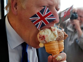 Conservative party leadership candidate Boris Johnson holds ice cream in Barry Island, before a hustings event with leadership rival Jeremy Hunt in Cardiff, Britain.