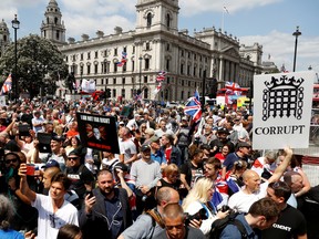 Supporters of far-right activist Stephen Yaxley-Lennon, who goes by the name Tommy Robinson, protest outside the Houses of Parliament at Parliament Square in London, Britain, July 11, 2019.