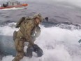A U.S. Coast Guardsman jumps onto the vessel containing 17,000 pounds of cocaine.