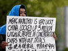 A woman holds a sign protesting China’s treatment of Uighur people in the Xinjiang region during a court appearance by Huawei’s Financial Chief Meng Wanzhou, outside of B.C. Supreme Court in Vancouver, May 8, 2019.