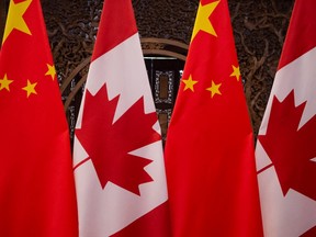 In this file photo taken on December 5, 2017 shows Canadian and Chinese flags taken prior to a meeting with Canada's Prime Minister Justin Trudeau and China's President Xi Jinping at the Diaoyutai State Guesthouse in Beijing.