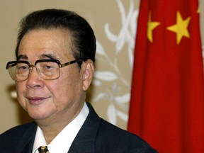 Chairman of the National Congress of the People's Republic of China Li Peng stands next to a Chinese flag in Canberra's Parliament House in Australia September 16, 2002.