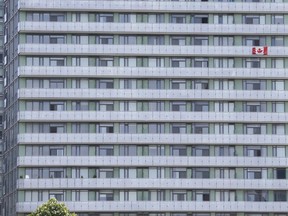 A downtown condo unit near Fort York unfurls a flag off a balcony on Monday July 1, 2019.