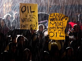 Wet snow falls as protesters demonstrate against the Enbridge Northern Gateway Pipeline in Vancouver, B.C., on Monday January 14, 2013. Canada's spy service routinely welcomed reports from the energy industry about perceived threats, and kept such information in its files in case it might prove useful later, newly disclosed documents reveal.