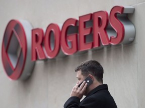 A man speaks on a mobile phone outside Rogers Communications Inc.'s annual general meeting of shareholders in Toronto on Tuesday, April 22, 2014. Rogers Wireless says customers may experience intermittent issues making or receiving wireless voice calls.