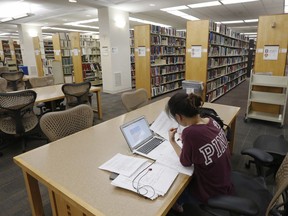 A student works in the library at Virginia Commonwealth University in Richmond, Va. on June 20, 2019.Federal officials warned in a presentation earlier this year that the risk of student loan defaults and delays was on the rise, noting bleakly: the "system is broken." Federal student debt alone is approximately $17 billion and the federal government has to regularly write-off millions of dollars in loans it will never collect.