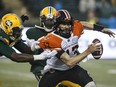 B.C. Lions quarterback Mike Reilly (13) is chased down by Edmonton Eskimos during second half CFL action in Edmonton, on June 21, 2019.