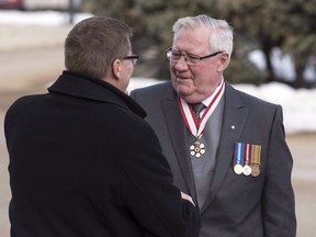 Saskatchewan Lieut.-Gov.Thomas Molloy is welcomed by Premier Scott Moe to the Legislative Building in Regina, Saskatchewan on Wednesday, March 21, 2018. Molloy died Tuesday of pancreatic cancer. He was originally from Saskatoon and previously had a legal career in which he negotiated numerous treaty settlements and agreements.THE CANADIAN PRESS/Michael Bell