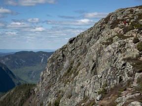 People hike to a lookout point in the Hautes Gorges de la Riviere Malbaie National Park, a park in the Charlevoix region of Quebec, on Sunday, June 10, 2018. As Quebec busiest summer holiday season begins with the province's construction holiday, vacationers may have their holiday plans impacted with the threat of a general strike looming among provincial park workers.