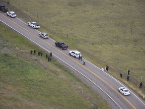 Police investigate the scene of a shooting along Highway 1A near Morley, Alta., in this August 2018 police handout photo. A German tourist shot while driving on a highway west of Calgary last year had eight bullet fragments removed from his brain during surgery. A trial has begun for a 17-year-old male from on the Stoney Nakoda First Nation accused in the shooting.