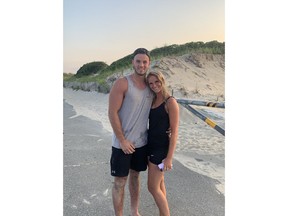 Gabriel Roy poses with his girlfriend Kasandra Rodgers in this handout photo on Horseneck Beach in Westport, Mass. A Quebec tourist is being credited with saving an eight-year-old boy who was swept away by an undertow and nearly drowned at a beach in southeastern Massachusetts.