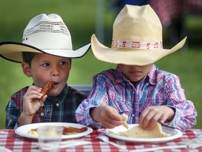 Young cowpokes enjoy a Stampede breakfast in Calgary, Saturday, July 6, 2019.