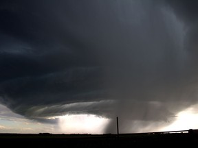 Alberta storm chaser Chris Kiernan has hardly had a moment's rest since the start of the tornado season last month. A supercell is seen over an area east of Calgary in a July 13, 2019, handout photo. As of Monday afternoon, there have been 18 tornadoes in the province according to Environment and Climate Change Canada.