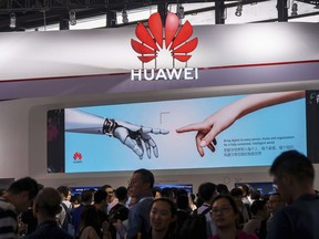 In this June 26, 2019, photo, visitors tour the Huawei pavilion at the Mobile World Congress in Shanghai, China. Canadians will have to wait until after this fall's federal election to find out whether Chinese tech giant Huawei can provide equipment for the country's next-generation 5G wireless network. (Chinatopix via AP)