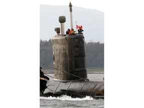 The Canadian submarine HMCS Chicoutimi comes up the River Clyde towards the British Naval Base at Faslane, Scotland, Sunday, Oct. 10, 2004. The Canadian submarine is being towed back to the UK after a fire broke out on board on its maiden voyage under Canada colours. Sailors who survived a devastating fire aboard the submarine HMCS Chicoutimi almost 15 years ago were expected to learn today details from a study into the long-term impact on their health.