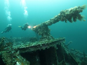 Divers explore the gun on the deck of the SS Saganaga shipwreck off the coast of Bell Island, N.L., in an undated handout photo. Undetonated explosives from four iron ore carriers that sank in 1942 German U-Boat attacks will be retrieved by military divers starting Monday.