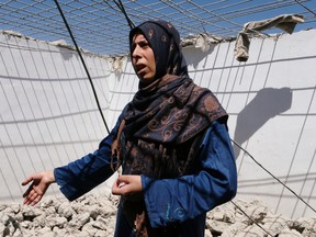 Dima al-Kanj, 30, a Syrian refugee, gestures near the rubble of her dismantled concrete hut at a makeshift Syrian refugee camp in the Lebanese border town of Arsal, Lebanon July 4, 2019.