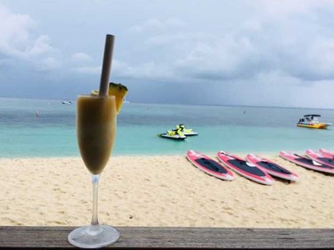 A pina colada with a view at Coccoloba on Seven Mile Beach.