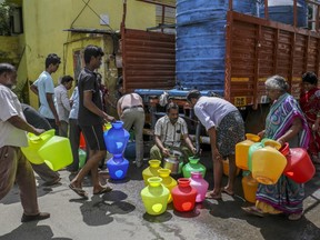 Residents fill pots from a water truck in Chennai, India, on Thursday, July 4, 2019. Failed rains last year and delays in this year’s annual monsoon have left nearly half of India facing drought-like conditions, according to the South Asia Drought Monitor.