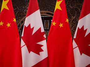 Canadian and Chinese flags are displayed at a meeting between Prime Minister Justin Trudeau and Chinese President Xi Jinping in Beijing on Dec. 5, 2017.