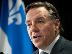 Francois Legault speaks to reporters at La Prairie Parti Quebecois MNA Francois Rebello riding office in St. Constant, Quebec Tuesday, January 10, 2012.