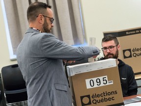 A man casts his ballot at a polling station in the provincial elections on October 1, 2018 in Montreal, Quebec, Canada.