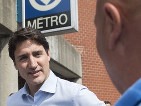 Prime Minister Justin Trudeau greets commuters outside St. Michel metro station in Montreal, Thursday, July 4, 2019.