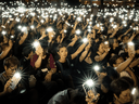 People wave their mobile phones in the air during a protest against alleged police brutality and the proposed extradition treaty on June 5, 2019 in Hong Kong.