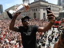 Kawhi Leonard takes a selfie holding his playoffs MVP trophy as he celebrates during the 2019 Toronto Raptors Championship parade in Toronto on June 17, 2019. 