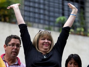 Judge Maria Lourdes Afiuni waves to supporters outside her house in Caracas.