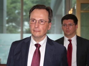 Acting Russian ambassador to South Korea, Maxim Volkov (L), arrives at the foreign ministry in Seoul on July 23, 2019 as he was called to the ministry after a Russian military aircraft allegedly violated South Korean airspace.