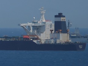 A British Royal Navy patrol vessel guards the oil supertanker Grace 1, that's on suspicion of carrying Iranian crude oil to Syria, on July 4, 2019.