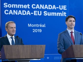 President of the European Council Donald Tusk responds to a question as Prime Minister Justin Trudeau listens during the closing news conference of the Canada-EU Summit in Montreal on Thursday, July 18, 2019.