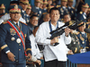 Philippine President Rodrigo Duterte holds a Galil sniper rifle next to outgoing Philippine National Police Chief Ronald Bato Dela Rosa during the National Police chief handover ceremony on April 19, 2018.