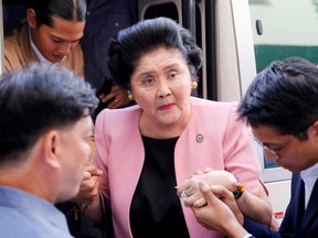 Aides help former Philippine First Lady Imelda Marcos walk, as she arrives at an anti-corruption court Sandiganbayan, to attend a court hearing in Quezon City, Metro Manila, in Philippines November 16, 2018.