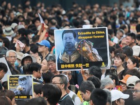 Protesters gather before a march to the West Kowloon railway station, where high-speed trains depart for the Chinese mainland, during a demonstration against a proposed extradition bill in Hong Kong on July 7, 2019.