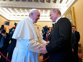 This photo taken and handout on July 4, 2019 by the Vatican Media shows Pope Francis (L) greeting Russian President Vladimir Putin upon his arrival for a private audience at the Vatican. - Russian President Vladimir Putin arrived in Rome for a lightning visit including talks with the pope and Italy's populist government, which has called for an easing of sanctions despite Moscow's ongoing crisis with the West.
