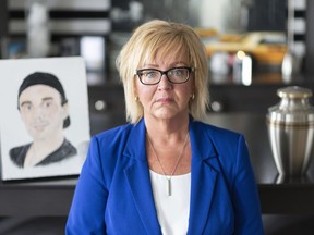 Jenny Churchill poses by a portrait of her son Jordan, who died of a fentanyl overdose in 2018, at her home in Regina on Friday, July 12, 2019.A mother whose son died of a fentanyl overdose wants the Regina Police Service to equip all front-line officers with the life-saving antidote naloxone.